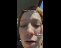 Girl holding adopted puppy in car 