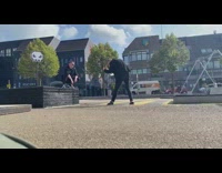 Guy black jacket squat on fountain ledge