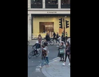 Woman in brown floral dress middle of street photoshoot