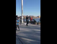 People hold metal railing while moving feet