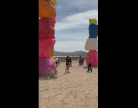 Collab IITW - Lady Wearing Black Poses with Colorful Rocks 