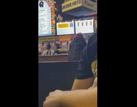 Man wearing red oxygen mask at food counter