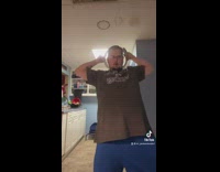 Guy takes shirt off dances with plungers 