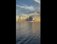 View of the sun on the horizon behind the clouds