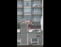 Guy shaves belly and chest on roof top