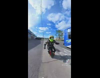 Guy wearing green helmet rides onewheel