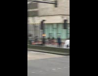 large group of guys ride bicycles street