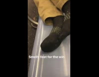 Guy puts his smelly feet out on subway seat