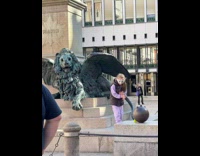 Little girl in a mask tiktok dance by the statue