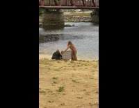 Brown dress lady holds white light reflector 