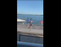 Guy blue shirt funny poses boat boardwalk