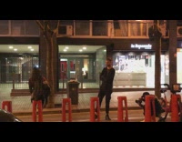 couple stand red bike racks