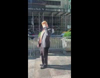 Trump costume person waves guy black suit