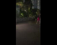 Woman in red dress poses in the indoor waterfalls