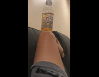 Gatorade drink bottle balanced by filmer on its knees