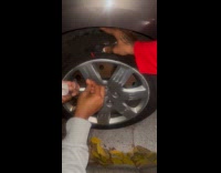 Woman puts scotch tape on flat tire