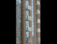 blow up doll on balcony of building