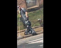 Man cleaning sidewalk with pressure washer 