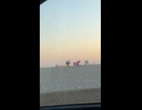 Woman pink dress twerks for beach video