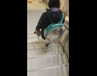 Collab Subway Creatures - Lady wears blue backpack with dog inside 