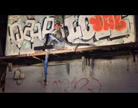 Weird formed statue on the vandalized billboard