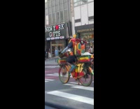 Man wearing strange outfit on bike 