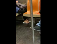 Lady puts bare feet on shoes subway 