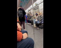 Man performs inside subway hangs in handrails