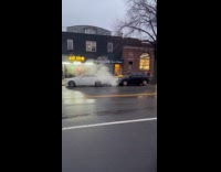 Smoke comes out from drainage between two cars