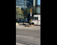 Guy lay on road block USPS truck