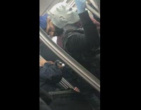 Guy in goblin monster mask blue skin on subway train