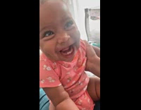 Baby in pajama laughing uncontrollably