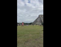 Woman in pink outfit poses at the Chichén Itzá