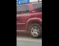 People in white hazmat suits filming on the street