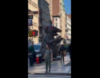 Huge inflatable rat displayed on sidewalk