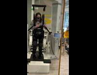 Woman walk with robot apparatus attached legs