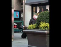 Guy sings by subway station entrance 
