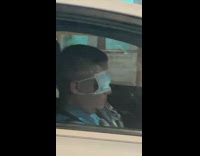 Man in car has blue mask over eyes
