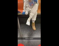 Man in white tuxedo and blue fedora hat has mismatched shoes, one brown boot