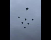 Seven jets fly in arrow shape formation 