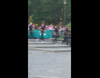 Man in blue cube costume jumps around in circle in Union Square Pride parade