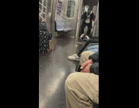 Guy doing a weird step dance to song on subway