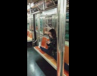 Woman does the splits on subway seats while texting on phone