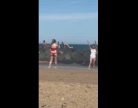 Man red briefs bend body beach rocks