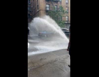 Broken fire hydrant splash water on street
