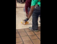 Man picking up spilled weed on subway station floor 