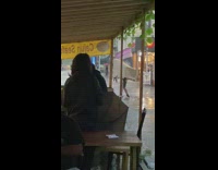 Man uses large cardboard as umbrella