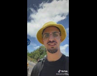 Guy in yellow hat finds blue stop sign