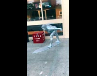 Silver surfer cosplay with tip box in street
