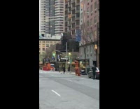 Inflatable dinosaur listens to performer sing piano  